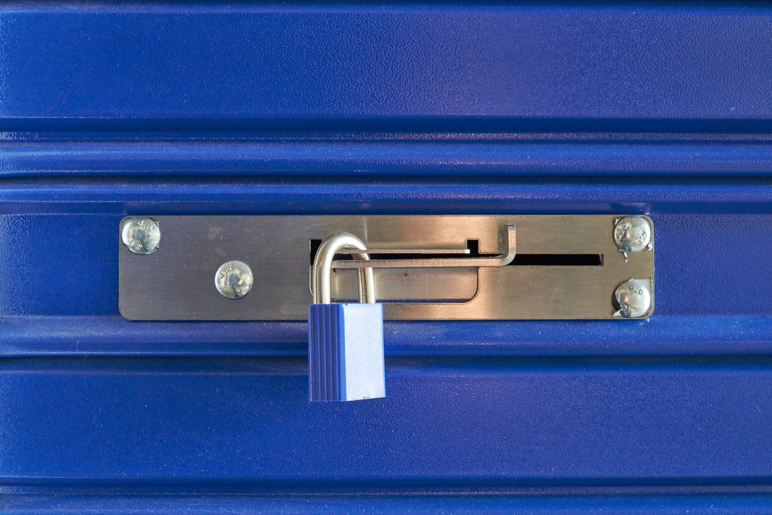 a-blue-locked-lock-on-a-metal-barrier-in