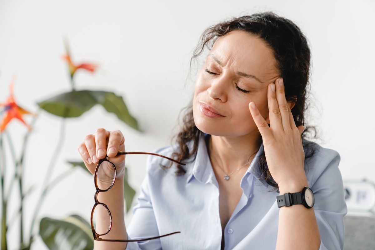 Headache. Exhausted tired depressed stressed mature businesswoman suffering from migraine at work. Sad ill sick middle-aged woman having overwork or menopause at home office.