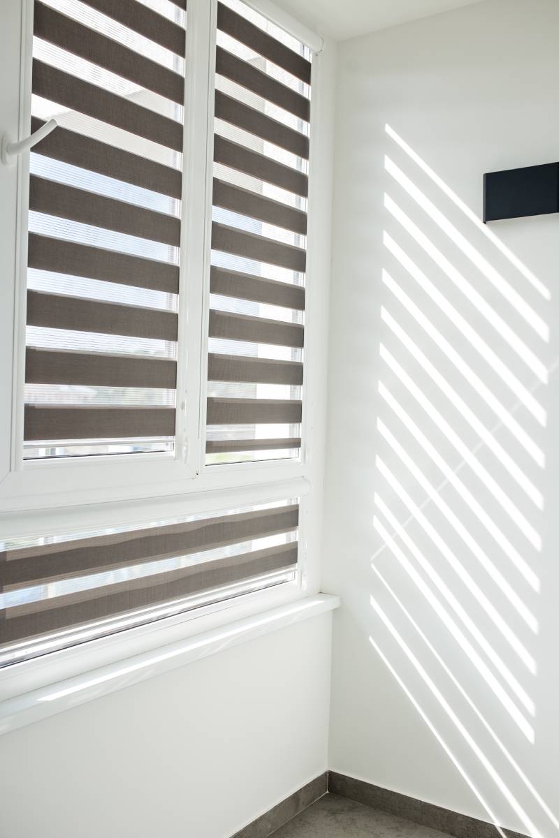 Roller blinds on balcony windows. Beautiful window blinds, sun protection, ideal decoration for windows in interior