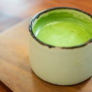 Japanese green tea in glass place on wooden tray.