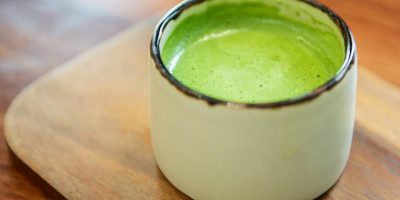 Japanese green tea in glass place on wooden tray.