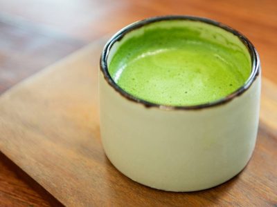 Japanese green tea in glass place on wooden tray.