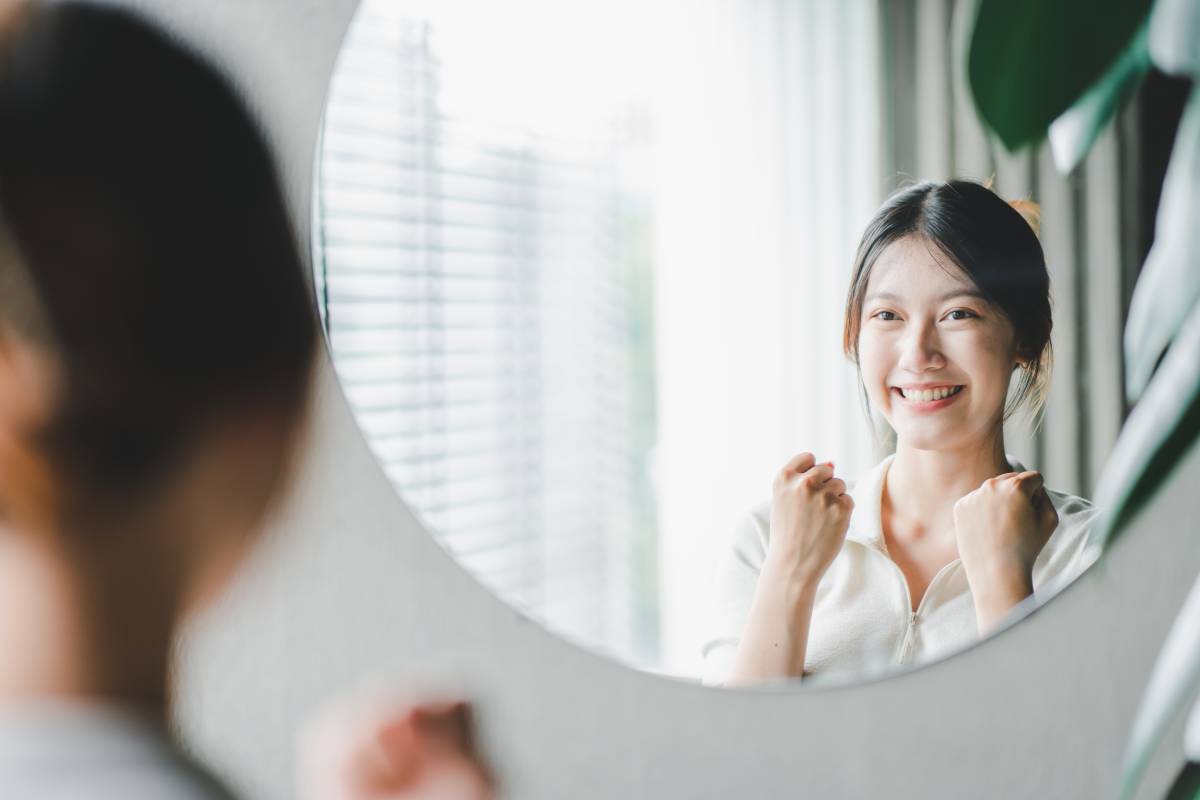 asian-woman-looking-through-the-mirror-and-confide-2023-11-27-04-51-31-utc (1)