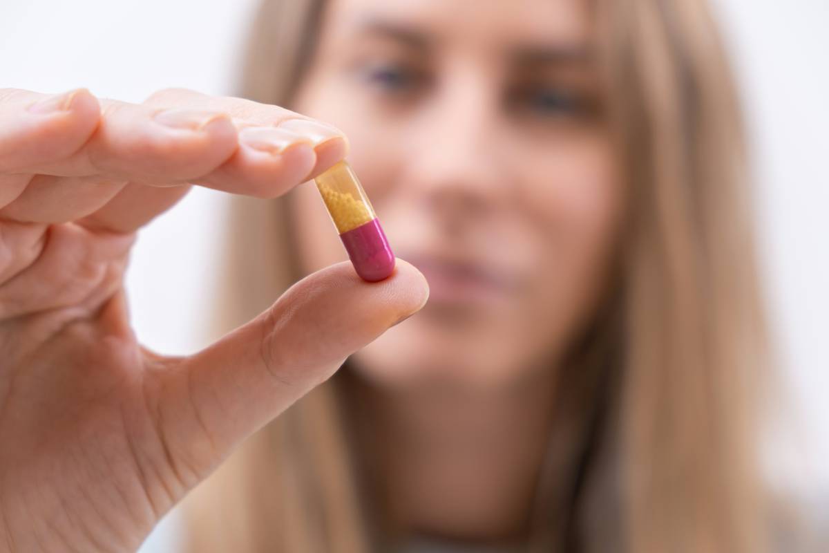 close-up-of-female-hand-holding-colorful-pill-or-c-2024-12-01-06-02-44-utc (1)