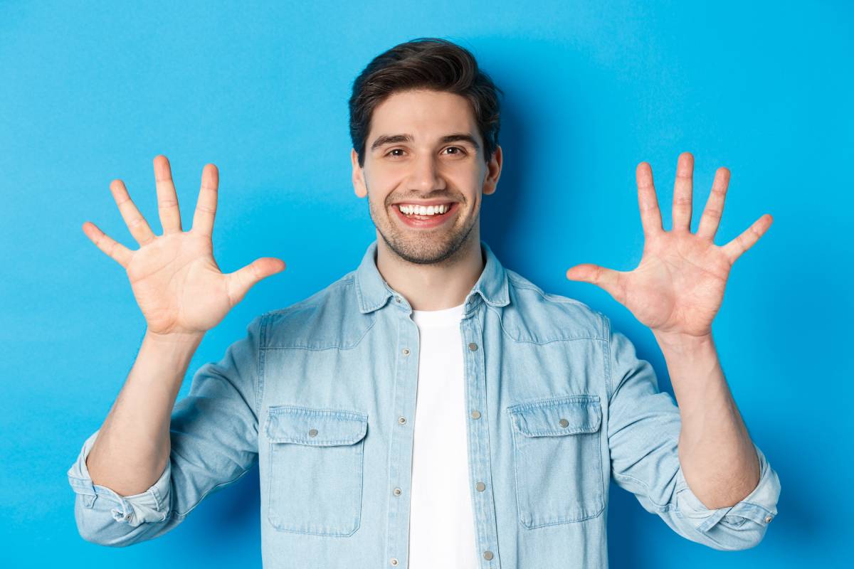 close-up-of-handsome-man-smiling-showing-fingers-2023-11-27-05-05-44-utc (1)