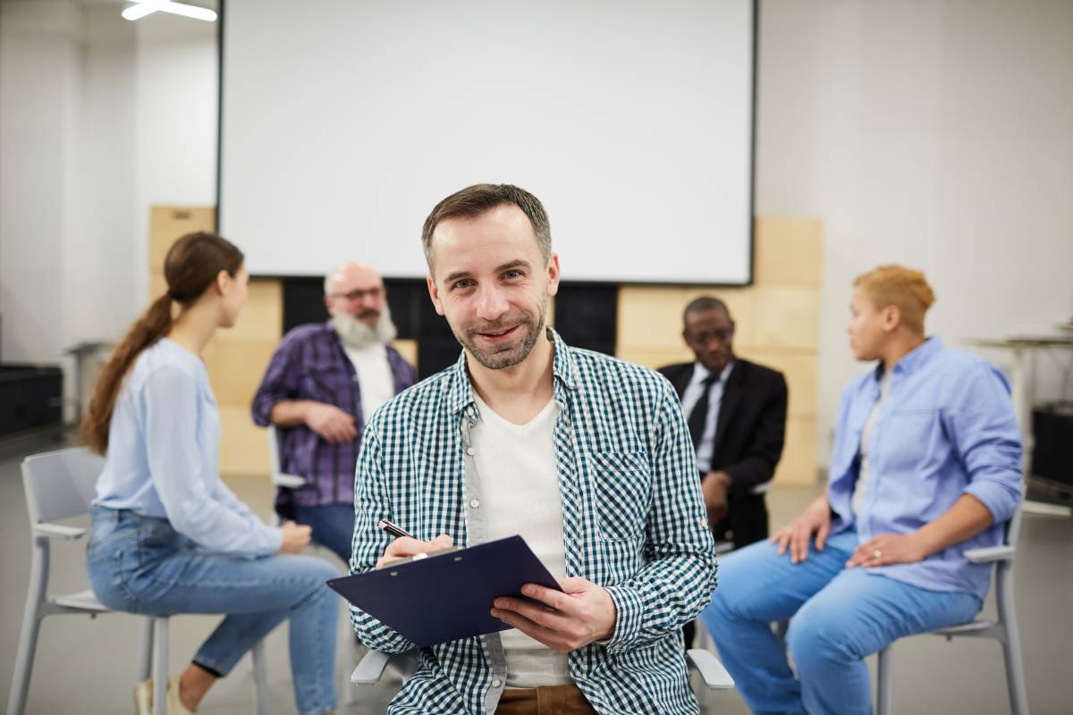 Mature Psychologist Posing in Group Therapy