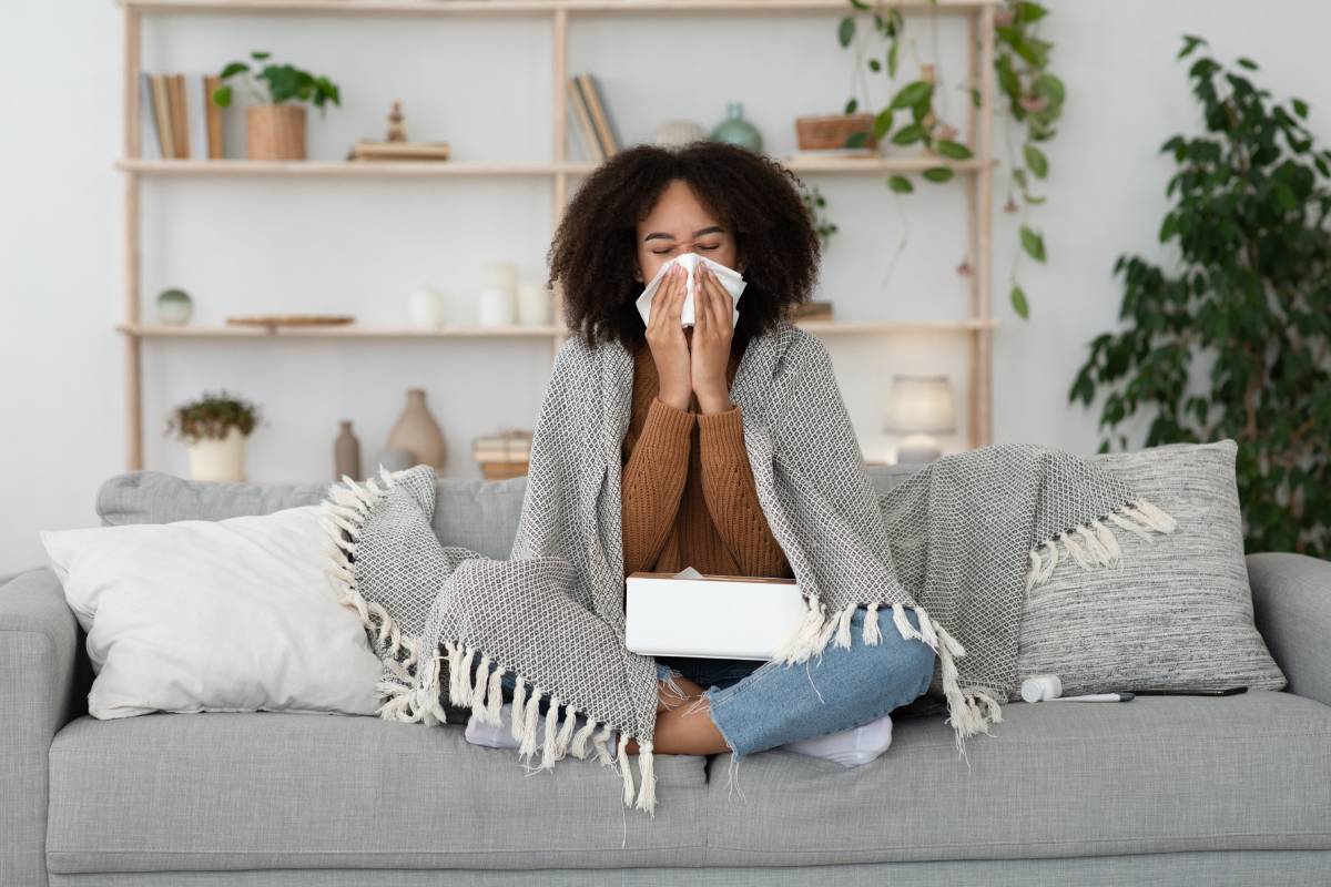 Sick day at home, treated, unhealthy african american millennial woman has runny nose, cough and common cold