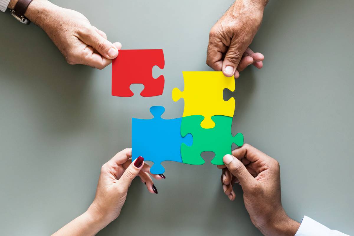 Business teamwork cooperation jigsaw isolated