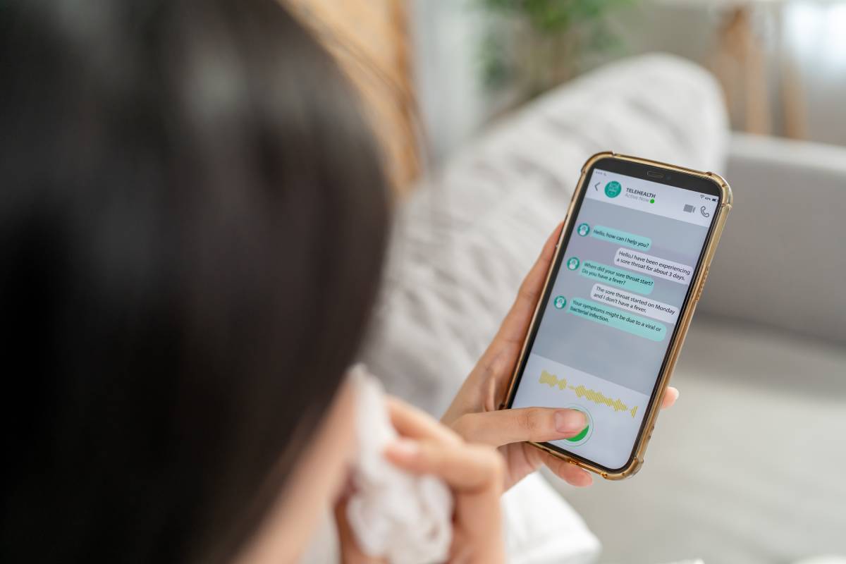 Close up of woman patient using phone apps consulting doctor online. Attractive female holding smartphone device sending text message and chatting remote for telemedicine telehealth treatment at home.