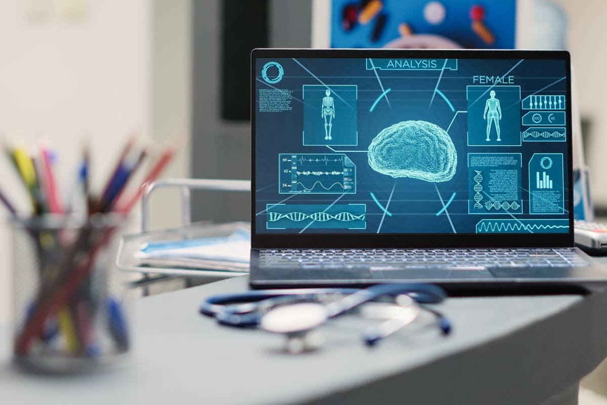 Laptop with human brain scan on desk