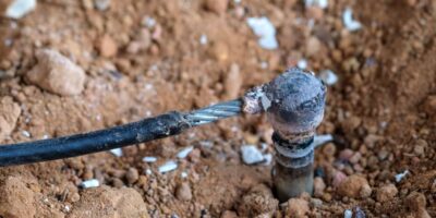 Welding copper ground wire on ground rod.